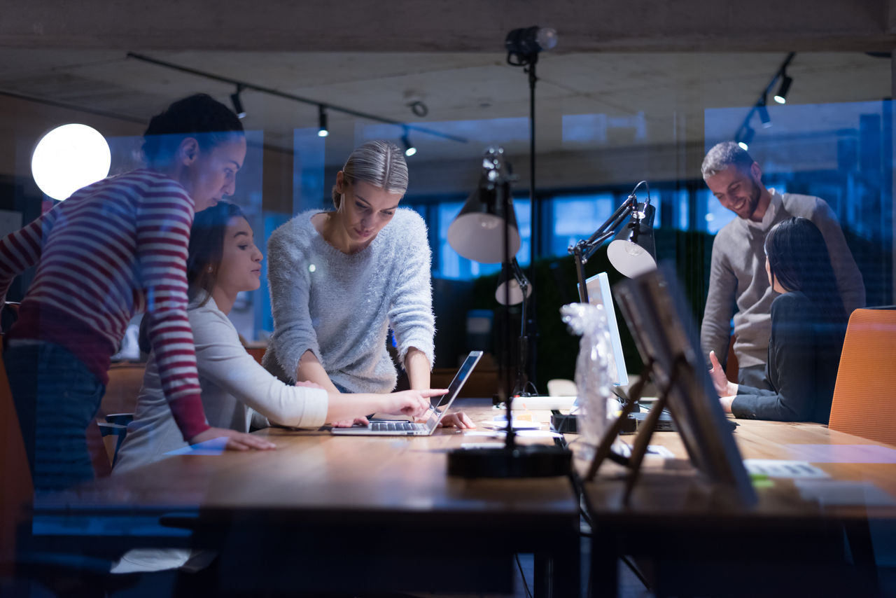 Meeting of co-workers and planning next steps of work. Young business group in discussion in their office. Startup people working in office.